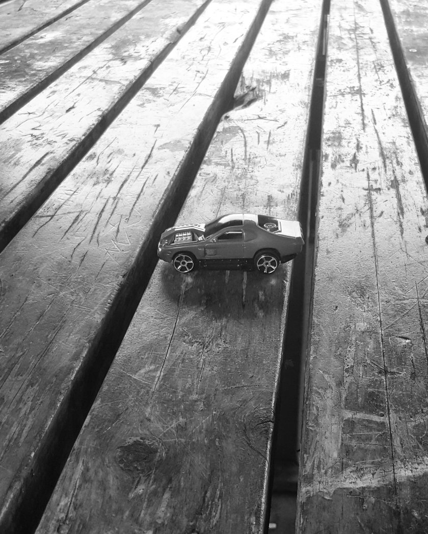 A toy car on a wooden table